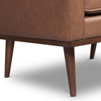 Fauteuil de salon moderne en cuir marron caramel avec dossier capitonné