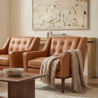 Fauteuil de salon moderne en cuir cognac avec dossier capitonné