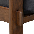 Fauteuil de salon moderne en cuir noir onyx avec dossier capitonné