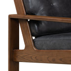 Fauteuil de salon moderne en cuir noir onyx avec dossier capitonné