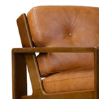 Fauteuil de salon moderne en cuir couleur cognac avec dossier capitonné