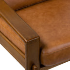 Fauteuil de salon moderne en cuir couleur cognac avec dossier capitonné